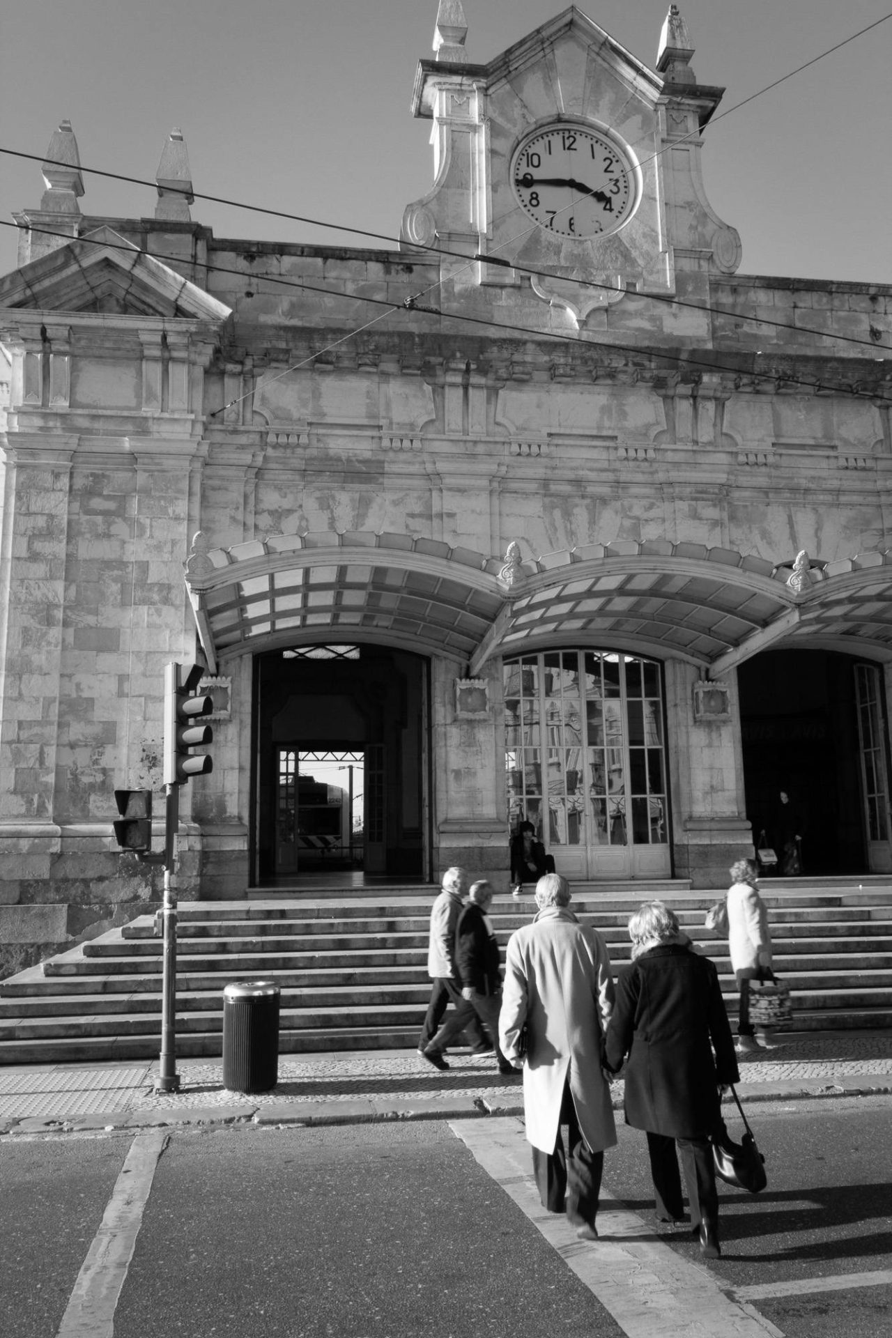 Black and white photograph of figures on the steps of a stone church façade